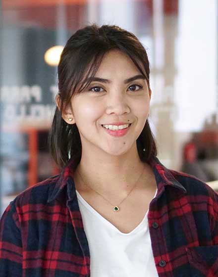 young short-haired woman smiling into camera