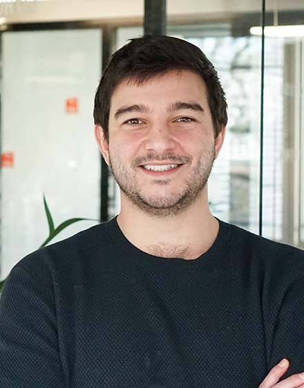 young dark-haired man smiling into camera