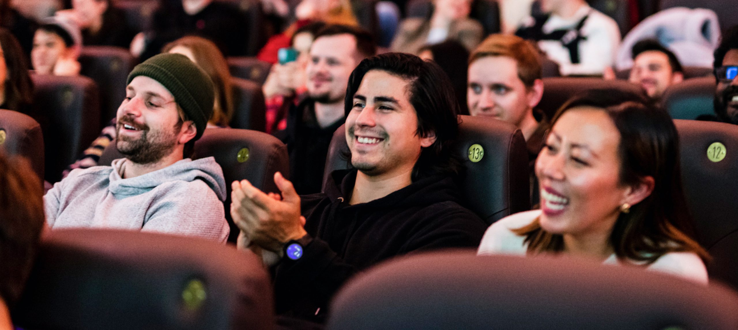adjoe employees laughing together in movie theater