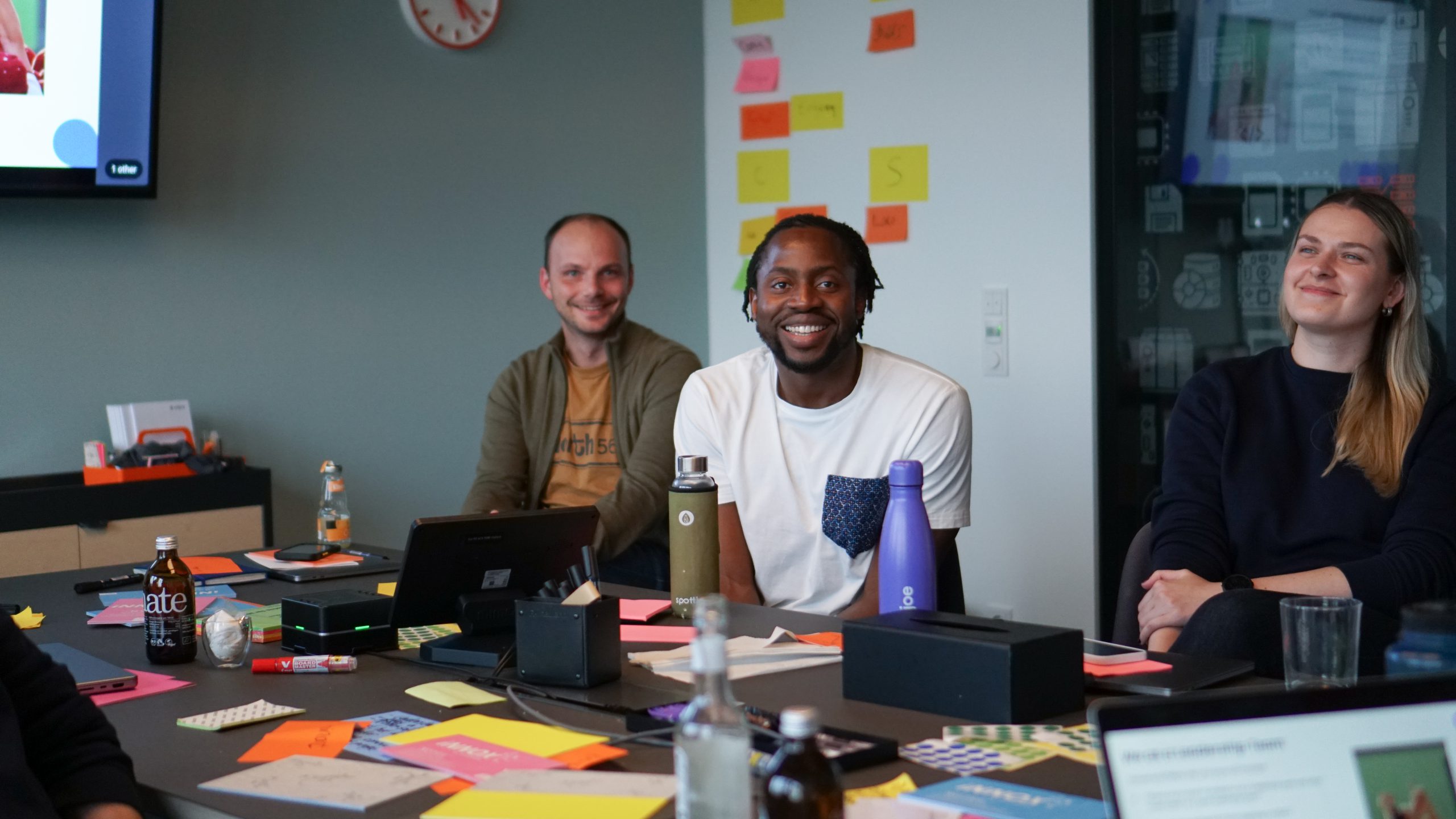 young crowd of people with developer jobsin a meeting room smiling