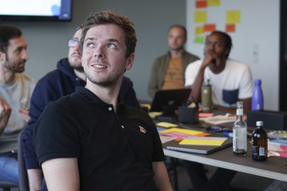 a group of men with developer jobs in a meeting room