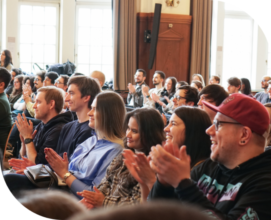 room full of people clapping their hands