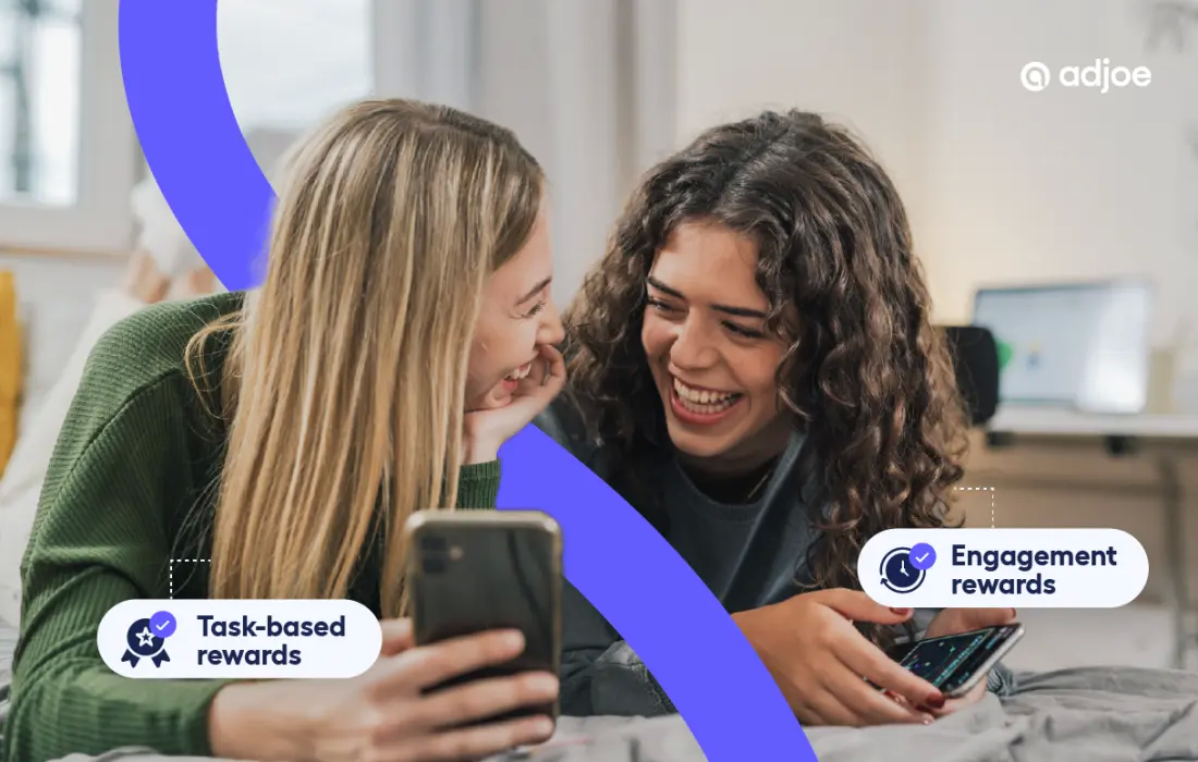 two young women laughing and looking at their phones