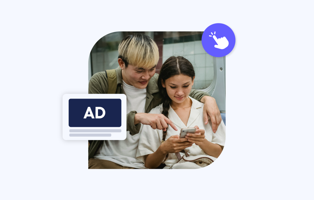 two young people looking over a phone